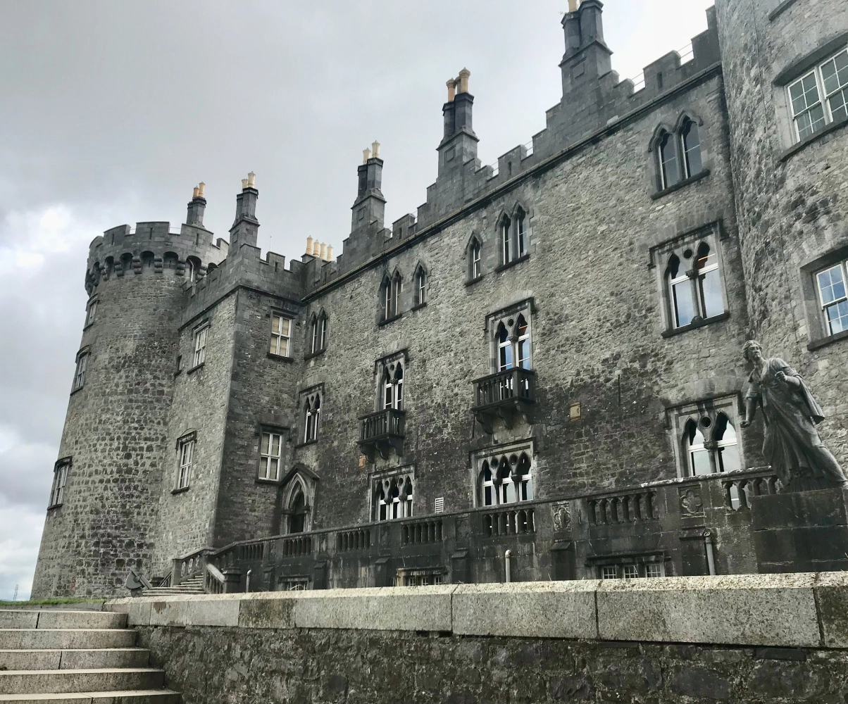 Medieval stone castle with towers and windows.