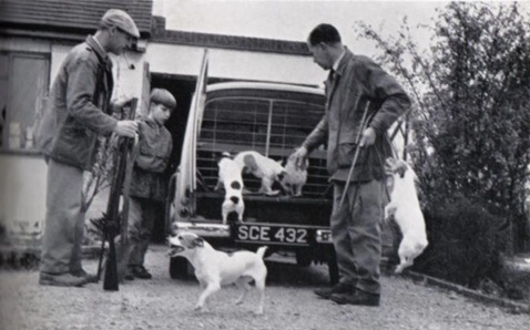Hunters with dogs and rifles by car. Hunters with dogs and rifles by car.