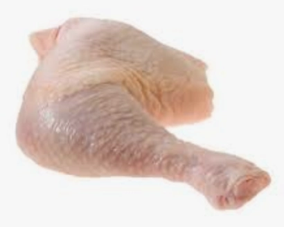 Raw chicken drumstick and thigh on white.