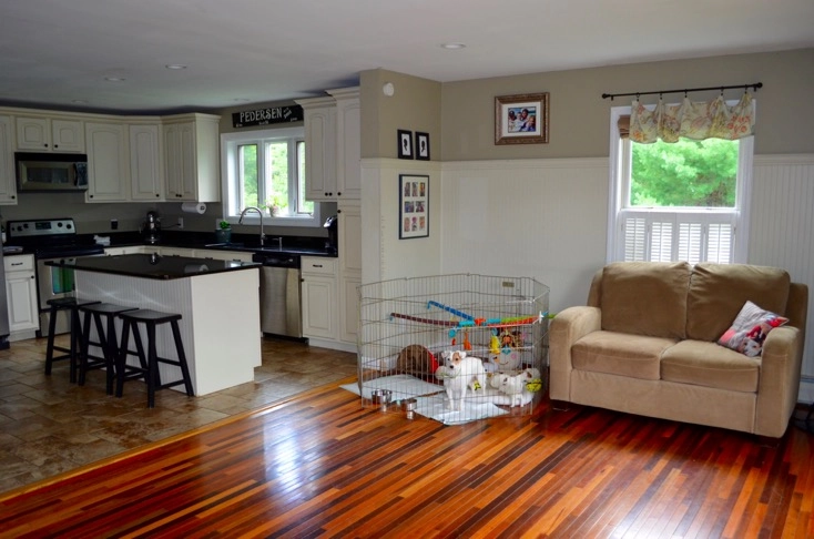 Open kitchen and living area with playpen.
